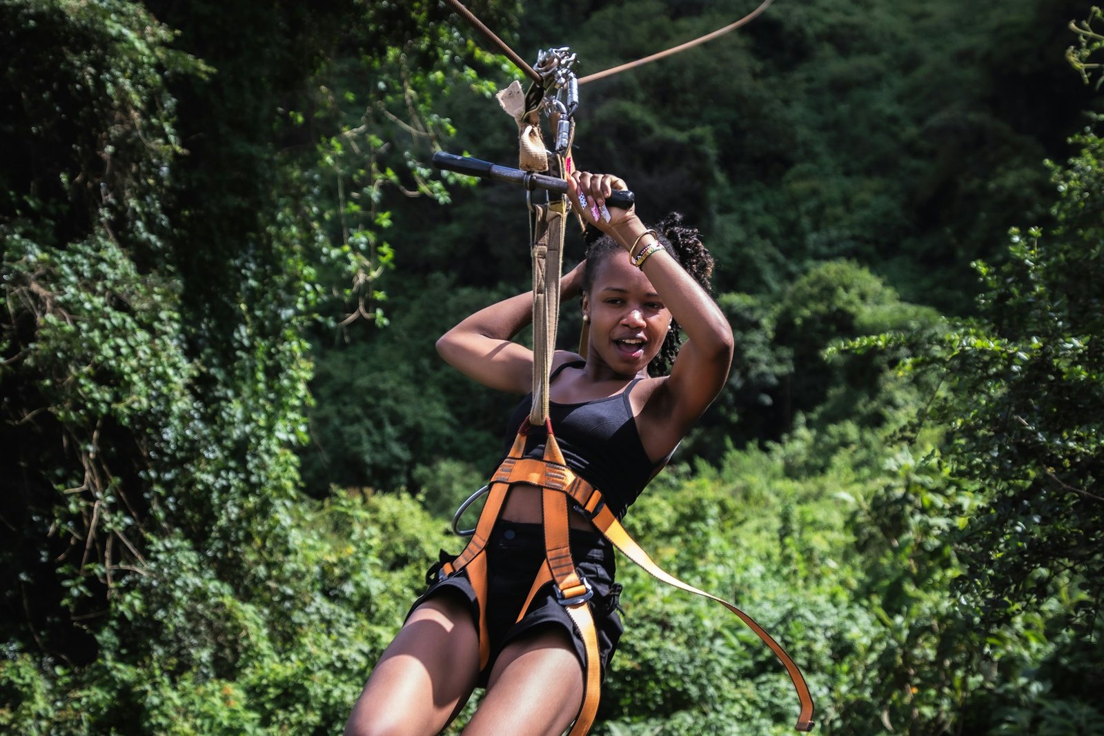 A woman on a zip line in the jungle A woman on a zip line in the jungle